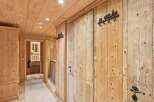 Step into rustic elegance with this stunning hallway, showcasing exquisite wooden paneling and a warm, inviting ambiance.