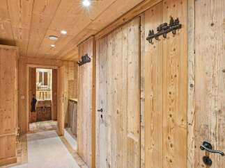 Step into rustic elegance with this stunning hallway, showcasing exquisite wooden paneling and a warm, inviting ambiance.