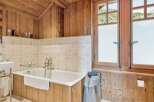 This stunning bathroom features a luxurious bathtub, perfect for unwinding after a long day.