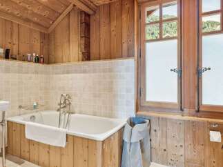 This stunning bathroom features a luxurious bathtub, perfect for unwinding after a long day.