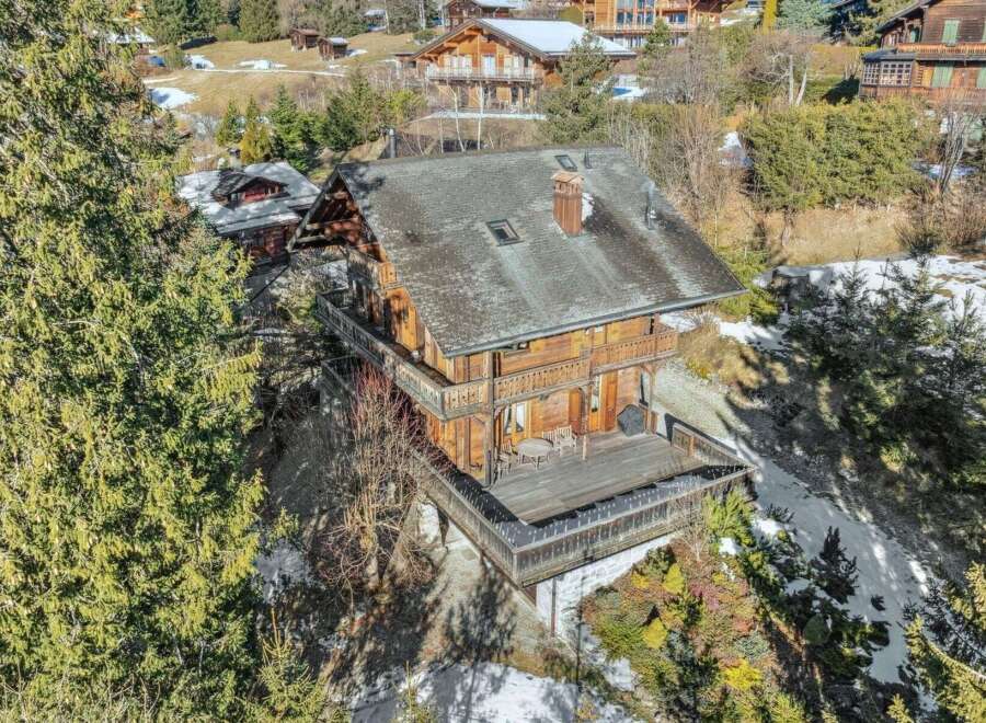 Nestled in a serene, snow-kissed landscape, this stunning wooden chalet offers an idyllic retreat.