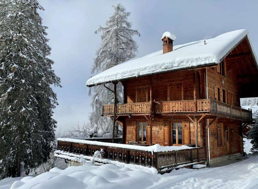 Experience the charm of this stunning wooden chalet nestled in a snowy wonderland.