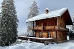 Experience the charm of this stunning wooden chalet nestled in a snowy wonderland.