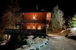 Experience the charm of this stunning wooden chalet nestled in a serene, snowy landscape.