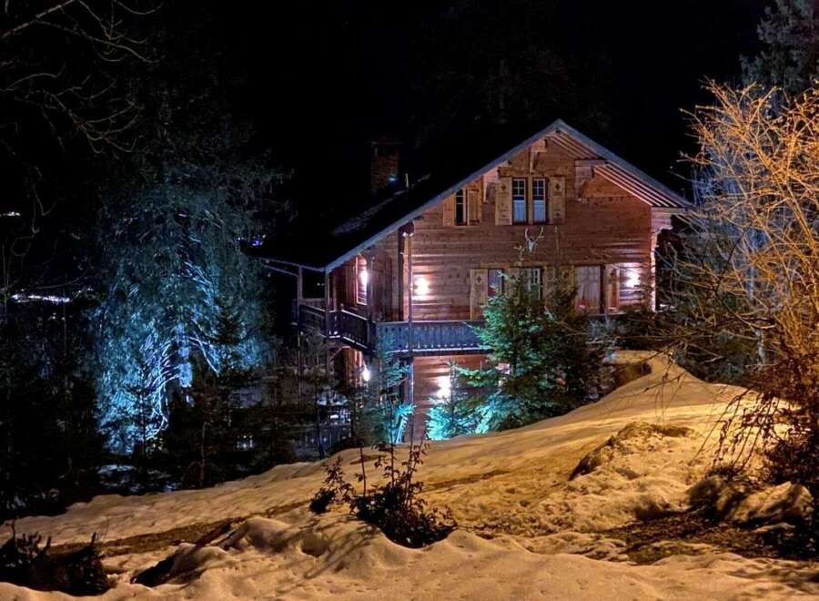 Nestled in a serene, snow-covered landscape, this charming wooden chalet offers a cozy retreat.