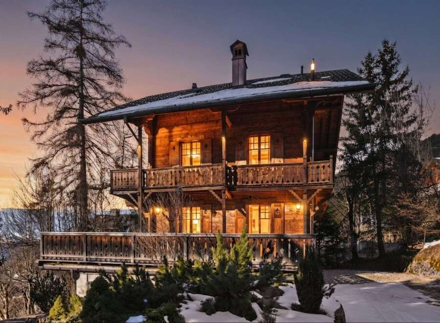 Experience the charm of this rustic wooden chalet, nestled amidst a serene winter landscape.