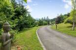 Discover serenity and elegance in this stunning property, featuring a winding driveway that leads to your dream home.