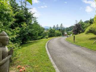 Discover serenity and elegance in this stunning property, featuring a winding driveway that leads to your dream home.