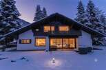 Experience luxury mountain living in this stunning chalet, nestled amidst snow-covered pines and majestic peaks.
