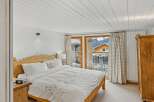 This charming bedroom offers a cozy retreat with a stunning mountain view.