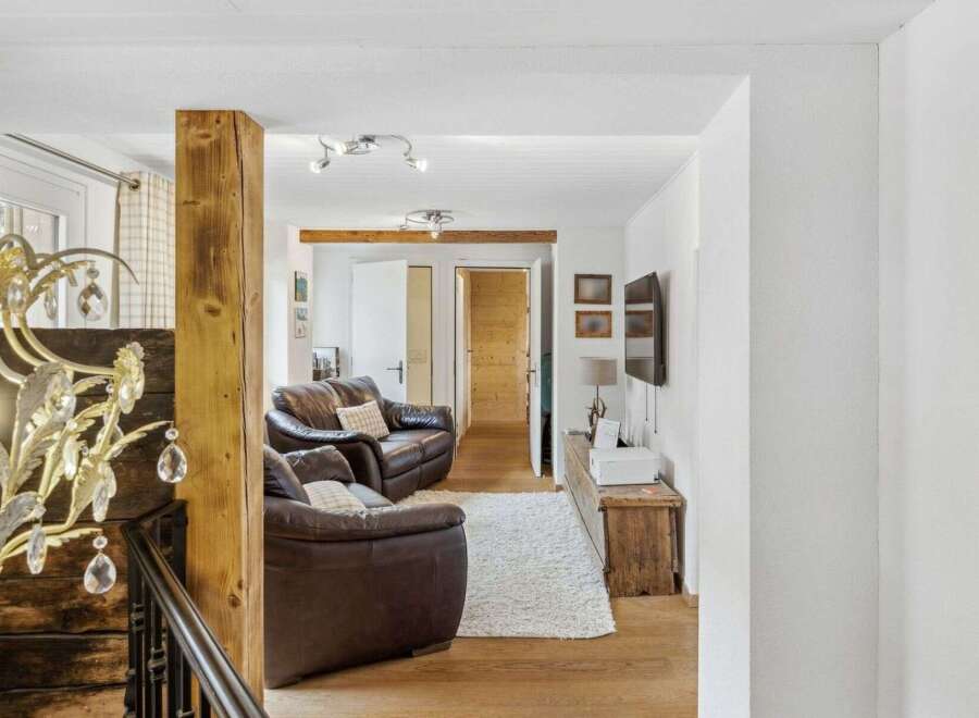 Step into this inviting living space, featuring a cozy seating area with comfortable leather sofas.