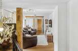 Step into this inviting living space, featuring a cozy seating area with comfortable leather sofas.