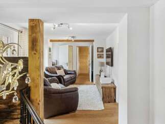 Step into this inviting living space, featuring a cozy seating area with comfortable leather sofas.
