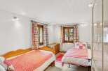 This charming bedroom features two cozy single beds, perfect for a comfortable stay.