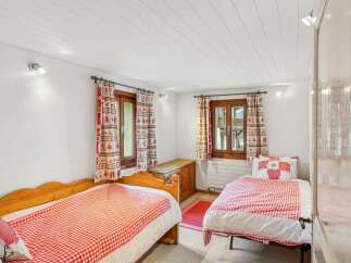 This charming bedroom features two cozy single beds, perfect for a comfortable stay.