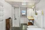 Discover the charm of this bathroom, featuring a sleek glass shower and a stylish wooden vanity.