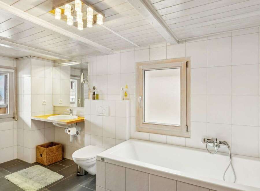 This charming bathroom features a bright and airy design, perfect for relaxation.