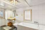 This charming bathroom features a bright and airy design, perfect for relaxation.