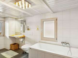 This charming bathroom features a bright and airy design, perfect for relaxation.