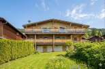 Experience alpine living in this stunning wooden chalet, featuring multiple balconies with scenic views and a charming garden.
