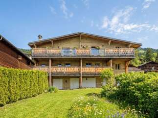 Experience alpine living in this stunning wooden chalet, featuring multiple balconies with scenic views and a charming garden.