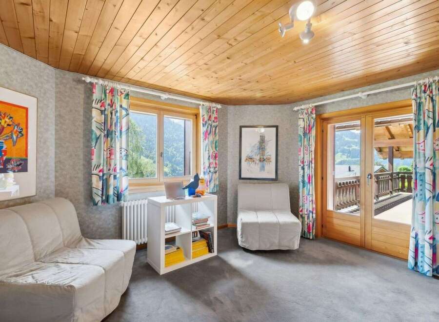 Discover the charm of this inviting living space, featuring a cozy seating area and a bright, airy ambiance.