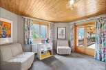 Discover the charm of this inviting living space, featuring a cozy seating area and a bright, airy ambiance.