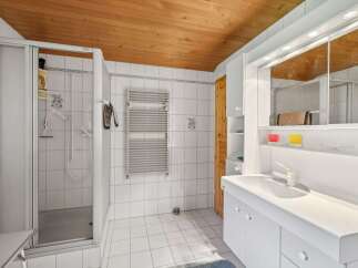 This stunning bathroom boasts a modern design with a touch of warmth.