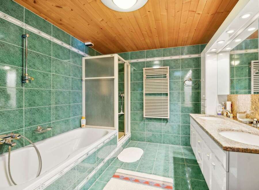 Step into this inviting bathroom, featuring a sleek shower enclosure and a luxurious bathtub.