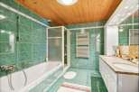 Step into this inviting bathroom, featuring a sleek shower enclosure and a luxurious bathtub.