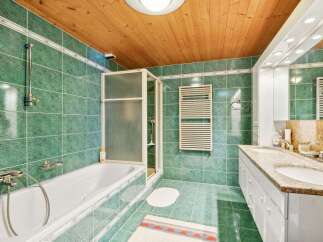 Step into this inviting bathroom, featuring a sleek shower enclosure and a luxurious bathtub.