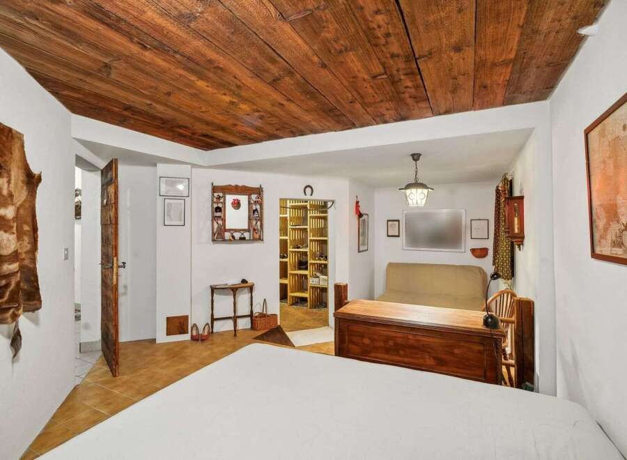 Step into rustic charm with this unique property featuring a stunning wooden ceiling and a cozy, inviting atmosphere.