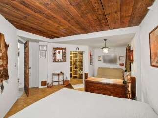 Step into rustic charm with this unique property featuring a stunning wooden ceiling and a cozy, inviting atmosphere.