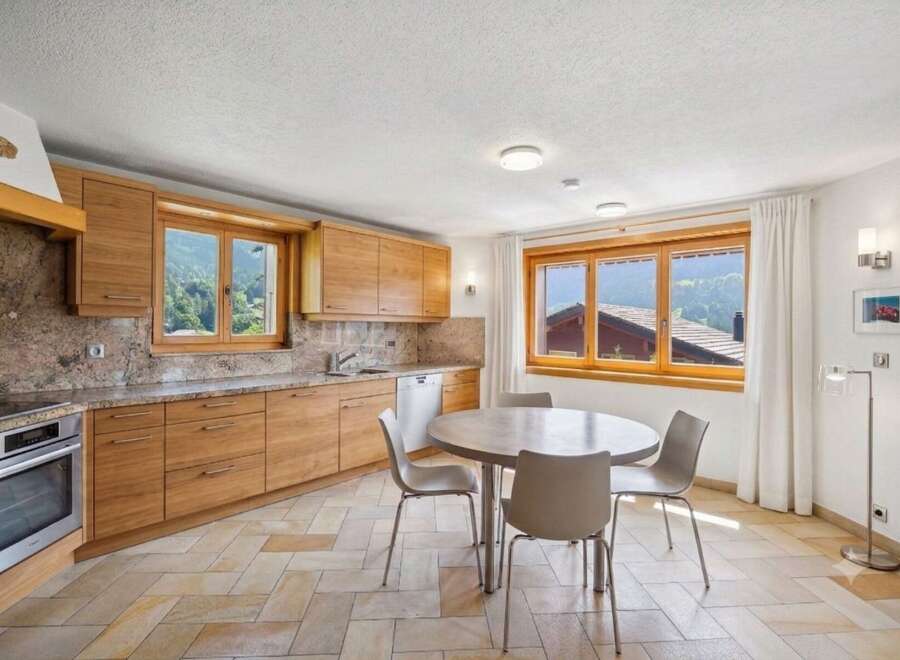 Experience the charm of this mountain kitchen, featuring warm wooden cabinetry and elegant granite countertops.