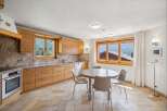Experience the charm of this mountain kitchen, featuring warm wooden cabinetry and elegant granite countertops.