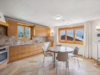 Experience the charm of this mountain kitchen, featuring warm wooden cabinetry and elegant granite countertops.