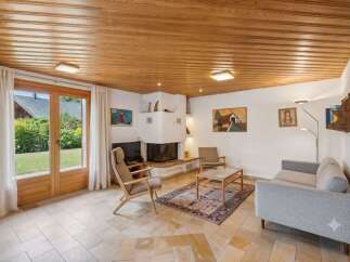 Experience cozy living in this charming living room featuring a modern fireplace and comfortable seating.