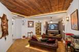 Experience cinematic entertainment in this unique basement media room, featuring plush leather sofas and a large screen perfect for movie nights.