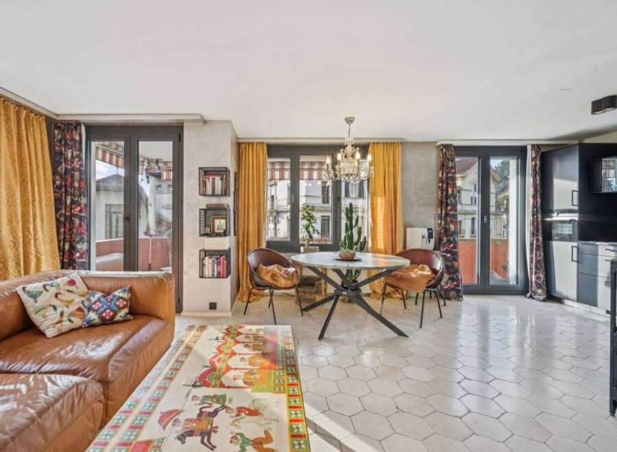 Discover this stunning property featuring a stylish living room with a comfortable leather sofa and vibrant decor.
