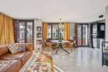 Discover this stunning property featuring a stylish living room with a comfortable leather sofa and vibrant decor.