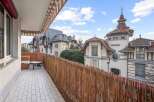 Enjoy stunning views from this charming balcony! This property features a cozy seating area and a unique woven fence, creating a private and inviting outdoor space.