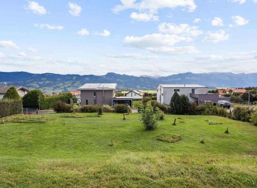 Discover your dream home in this picturesque setting! This stunning property boasts modern architecture, solar panels, and a spacious green lawn, perfect for outdoor activities.