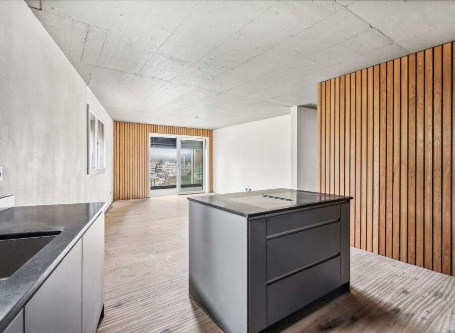 This modern kitchen boasts a sleek design with a central island and integrated appliances.