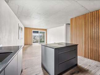 This modern kitchen boasts a sleek design with a central island and integrated appliances.