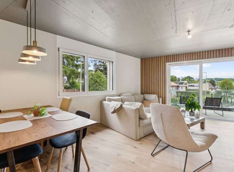 Experience modern living in this stunning property, featuring a bright and airy living space with a beautiful dining area.