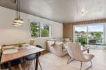 Experience modern living in this stunning property, featuring a bright and airy living space with a beautiful dining area.