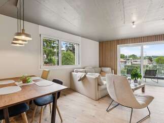 Experience modern living in this stunning property, featuring a bright and airy living space with a beautiful dining area.