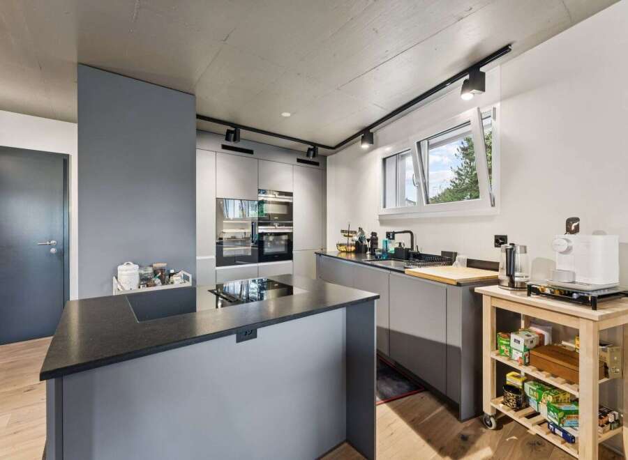 Modern kitchen design with sleek gray cabinetry and a stylish island.