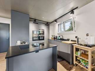 Modern kitchen design with sleek gray cabinetry and a stylish island.