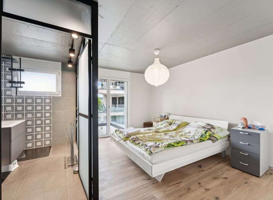 This modern apartment features a stylish bedroom with a minimalist design.